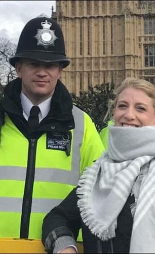 PC Keith Palmer, pictured with a member of the public in Westminster, was wearing a stab vest on the day of his death similar to the one shown in the video